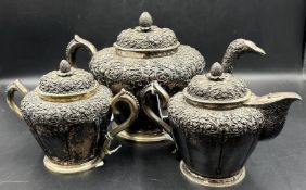 A continental silver, marked 800 three piece silver tea service with foliate decoration, approximate