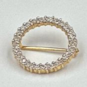 A 9ct gold brooch with white stones and approximately 20mm in diameter and 1.6cm in weight