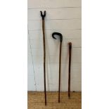 Two wooden shepherds staffs and a walking stick