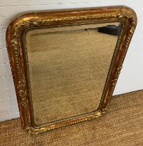 A French style giltwood mirror with carved scrolling corners 110cm x 73cm