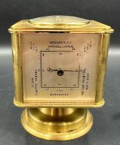 A vintage brass Angelus desk clock/weather station. Having rotating cube shaped body with alarm