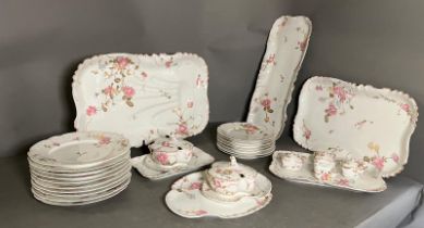 A Bennett Brothers china dinner service comprising of plates, meat plates, lidded pots etc (