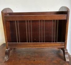 An Edwardian style mahogany magazine rack with lion head handles