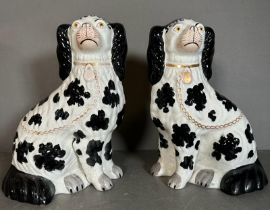 A pair of Staffordshire black and white spaniels