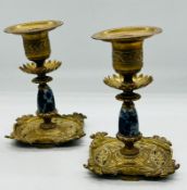 A pair of Aesthetic period brass candlesticks with blue and white ceramic columns and floral