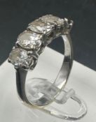 An 18ct gold five stone diamond ring with an missing stone, leaving four. Approximate size M1/2