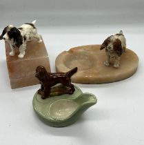 Three spaniel themed figures on bases