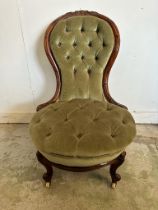 A mahogany Victorian button backed nursing chair in green