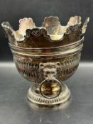 A silverplated punch bowl with detachable crown with lion ring handles and weighted base