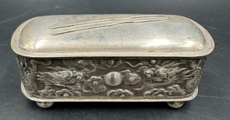 A Chinese silver hairpin or hat pin box decorated with dragons and on four small feet, makers mark