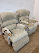 Two His and Her electric motorised reclining arm chairs upholstered in beige