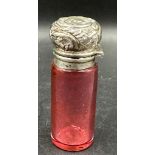 A cranberry glass and silver scent bottle hallmarked for Birmingham 1899.