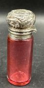 A cranberry glass and silver scent bottle hallmarked for Birmingham 1899.
