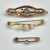 A selection of three 9ct gold brooches with various settings and styles, approximate total weight
