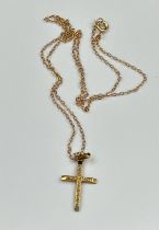 A 9ct gold cross on a fine necklace with an approximate total weight of 2g.