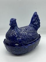 A Postmeridian blue ceramic, Hen on nest dish