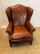 A leather wing back chair