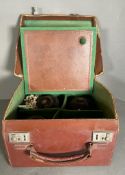 A set of four vintage lawn bowl balls in a brown leather case, monogrammed E.A.P