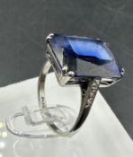 A platinum and 18ct white gold sapphire ring with diamond shoulders. Approximate size M