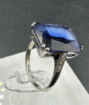 A platinum and 18ct white gold sapphire ring with diamond shoulders. Approximate size M