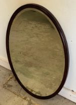 An oval mahogany framed bevel edged hall mirror 80cm x 54cm