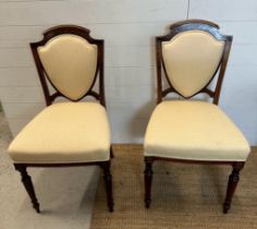 Six Edwardian shield back and inlaid hall chairs upholstered in white