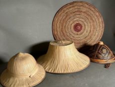 A selection of reed hats and woven mats