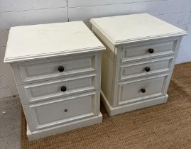 A pair of white painted three drawer bedside tables