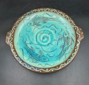 A Studio pottery plate, blue grounds with painted fish detail signed to back