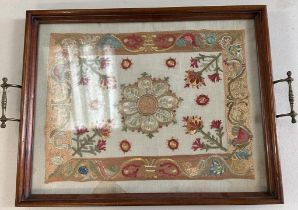 A mahogany framed glazed tray with a floral tapestry insert and brass handles