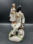 A Staffordshire figure of Uncle Tom and Little Eva
