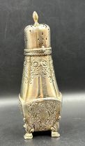 An ornate, foliate decorated, sugar shaker on four hoof feet with obscure hallmarks. Approximate