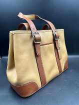 A tan leather coach handbag