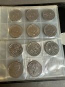 An album of collectable coins, some US, some UK Crowns, five five pound coins.
