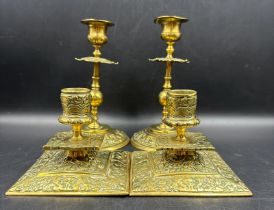 Two pairs of ornate brass candlesticks
