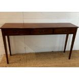 A mahogany three drawer console table with brass drop handles (H77cm W138cm D32cm)