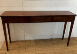 A mahogany three drawer console table with brass drop handles (H77cm W138cm D32cm)