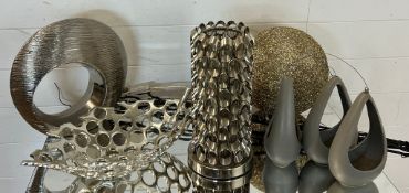 A collection of contemporary decor including dishes, plant holders etc