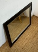 A mirror with a black frame
