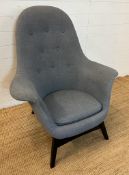 A grey Ikea button back arm chair
