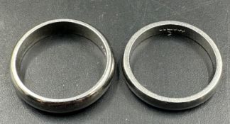 Two platinum wedding bands, approximate total weight 10.6g, and sizes L and M.