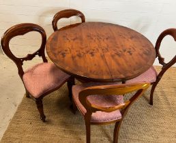 Circular dining table on down swept legs and metal capped lion paw ends with four balloon back