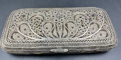 A silver filigree cigarette case