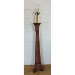 A wooden floor standing prop lamp with tapering base