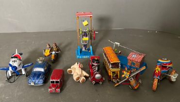 A selection of vintage tin toys and a miniature teddy bear