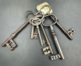 A set of antique keys , most on a key ring with a brass tag marked 4038 DUPE