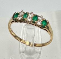 A 9ct gold fashion ring with czs and green stones.