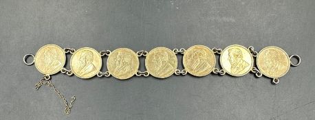 A bracelet of seven 7 South African silver gilt sixpences dated 1897