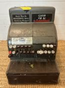 A vintage national cash register with key