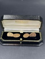 A boxed pair of Edwardian 9 carat gold, foliate engraved design cuff links, hallmarked for Chester